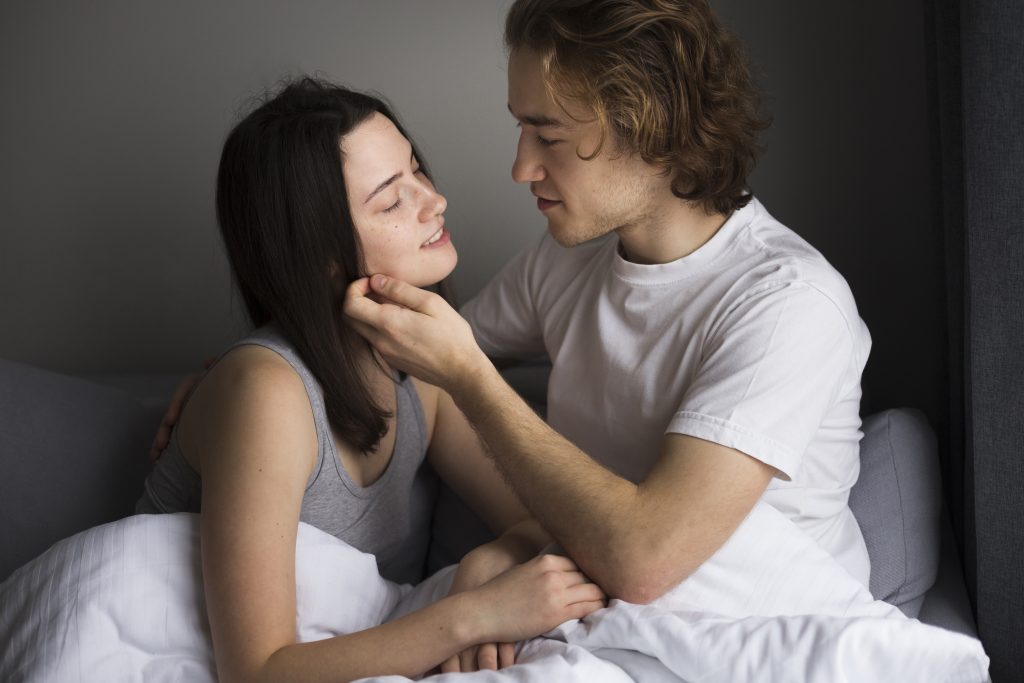 A couple exploring different positions for better sex as part of a healthy intimate relationship.